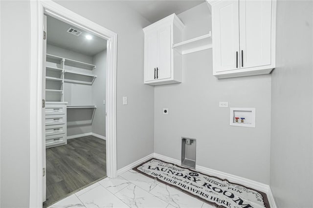 laundry room with hookup for an electric dryer, light hardwood / wood-style floors, cabinets, and hookup for a washing machine