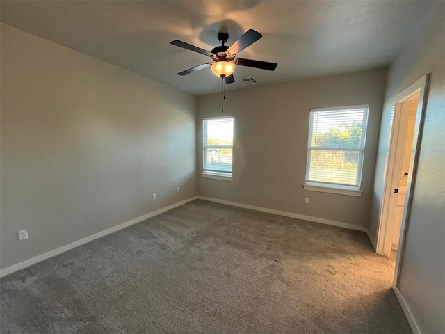 unfurnished room with carpet flooring and ceiling fan