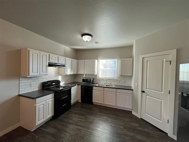 kitchen with black appliances, white cabinets, sink, dark hardwood / wood-style floors, and decorative backsplash