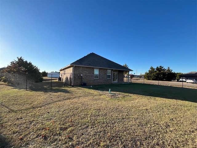 view of side of property with a yard