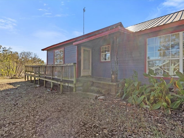 rear view of property with a wooden deck