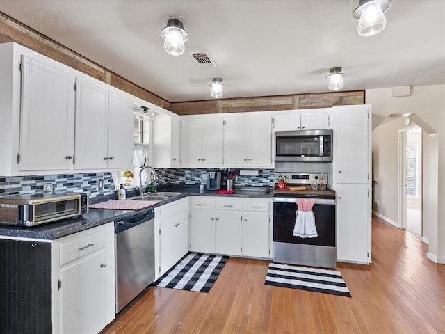 kitchen featuring white cabinets, appliances with stainless steel finishes, and sink