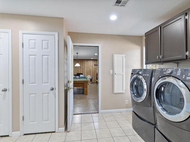 laundry area featuring wood walls, cabinets, billiards, light tile patterned floors, and separate washer and dryer