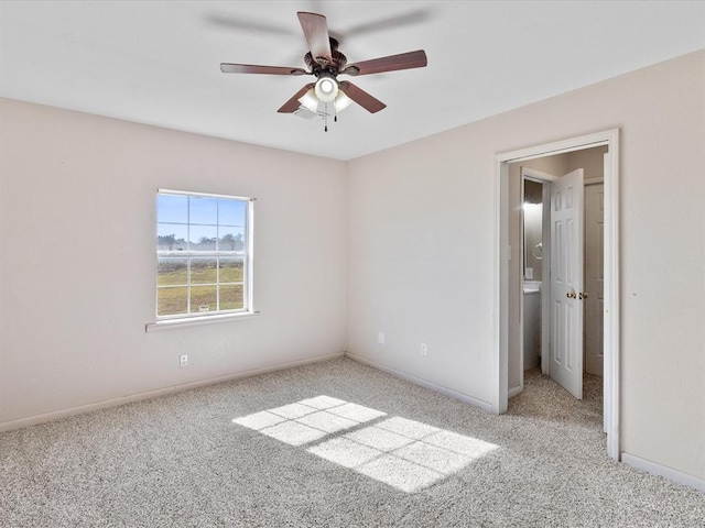 unfurnished bedroom featuring baseboards, carpet, and a ceiling fan