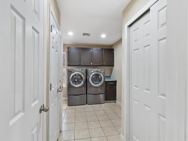 laundry area featuring visible vents, washing machine and clothes dryer, light tile patterned flooring, recessed lighting, and cabinet space