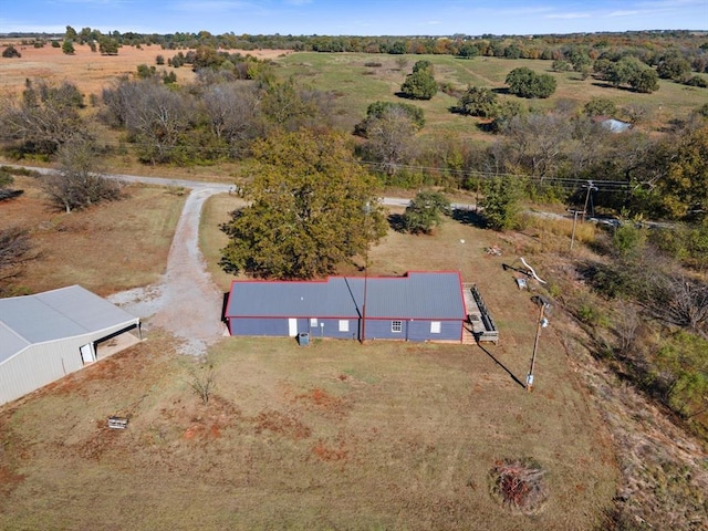 birds eye view of property with a rural view