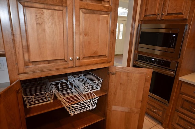 kitchen with light tile patterned floors and appliances with stainless steel finishes