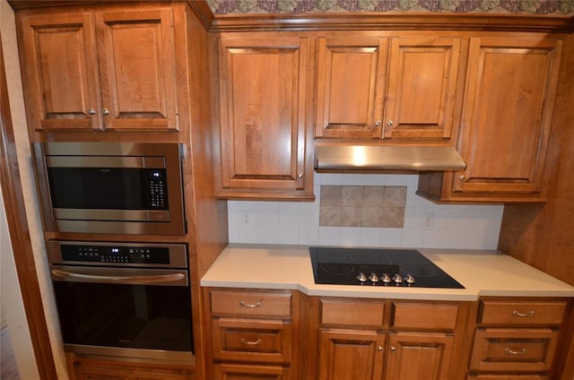 kitchen featuring stainless steel appliances and tasteful backsplash