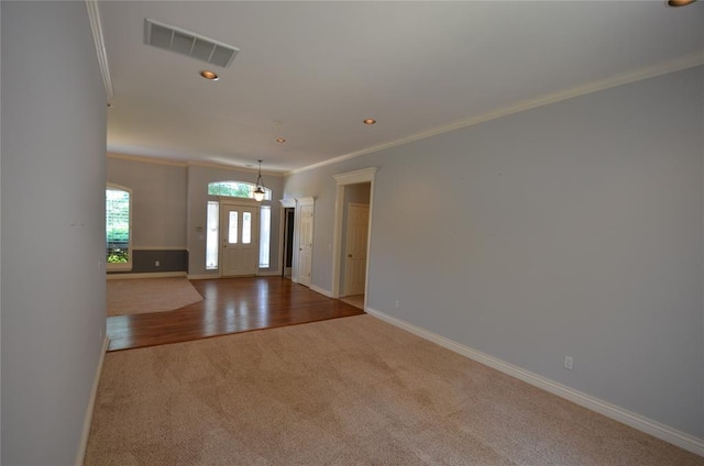 entryway featuring light wood-type flooring and ornamental molding