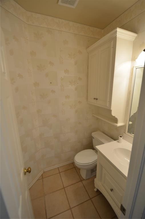 bathroom with tile patterned flooring, vanity, and toilet