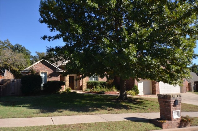 obstructed view of property with a front lawn