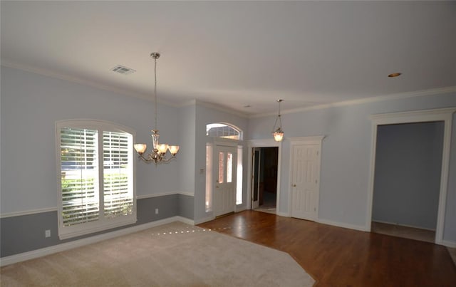 interior space featuring a chandelier, hardwood / wood-style flooring, and crown molding