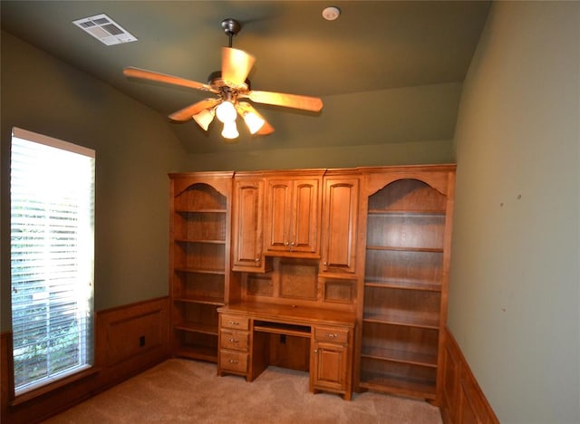 office area with ceiling fan, light colored carpet, lofted ceiling, and built in desk