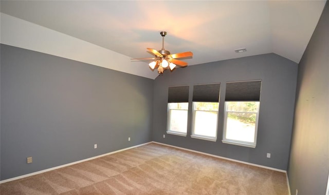 unfurnished room featuring light carpet, ceiling fan, and vaulted ceiling