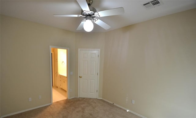 carpeted spare room with ceiling fan