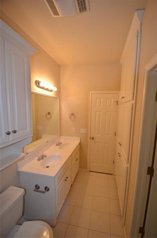 bathroom with tile patterned floors, vanity, and toilet