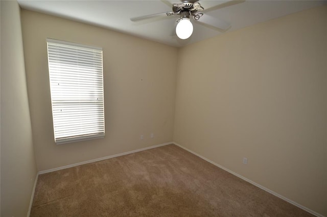 empty room featuring carpet flooring and ceiling fan