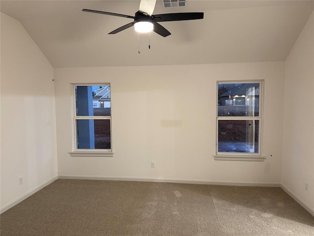 empty room featuring lofted ceiling, carpet, and ceiling fan