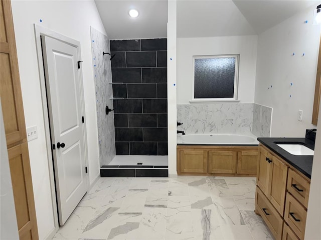 bathroom featuring vanity, separate shower and tub, and lofted ceiling