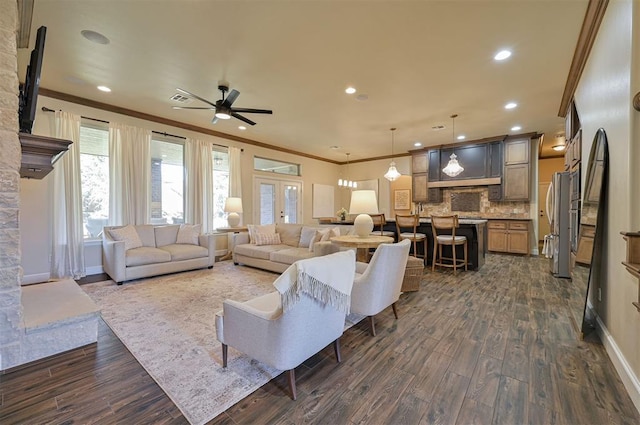 living room with dark wood finished floors, recessed lighting, french doors, and ornamental molding