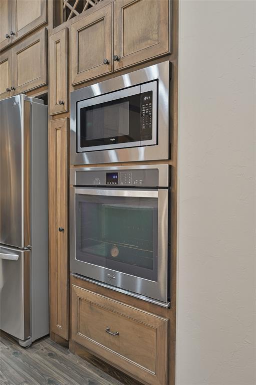 kitchen with stainless steel appliances and dark wood-type flooring