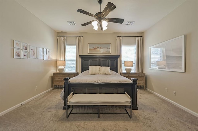 bedroom with light colored carpet, visible vents, and baseboards