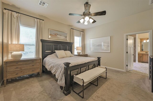 bedroom featuring visible vents, light colored carpet, baseboards, and ceiling fan