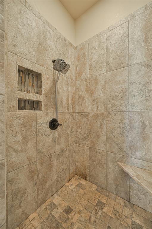 interior details with a tile shower