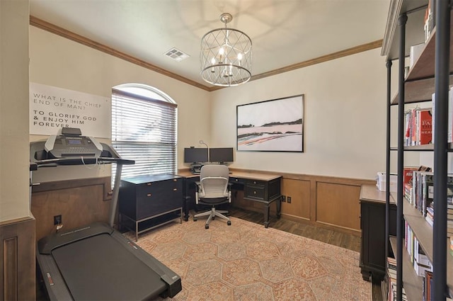 office area with visible vents, wood finished floors, an inviting chandelier, wainscoting, and crown molding