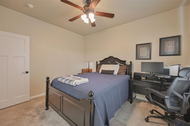 bedroom featuring light carpet, a ceiling fan, and baseboards