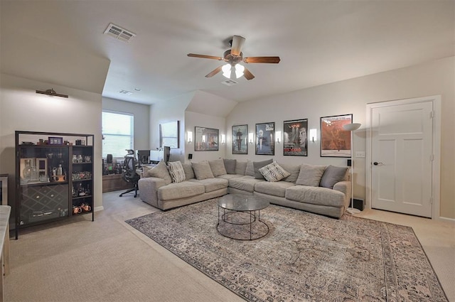 living area with visible vents, light carpet, and a ceiling fan