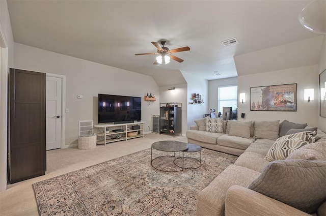 carpeted living area featuring visible vents, lofted ceiling, and a ceiling fan