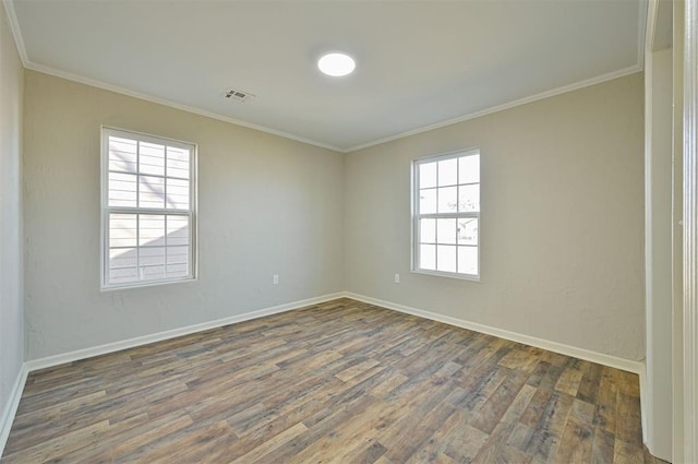 spare room with dark wood-type flooring and crown molding