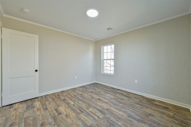 empty room with crown molding and wood-type flooring