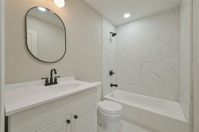 full bathroom featuring vanity, tiled shower / bath combo, and toilet