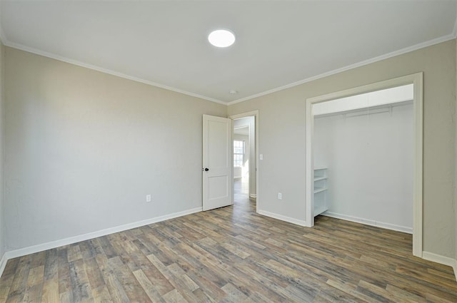 unfurnished bedroom with ornamental molding, dark hardwood / wood-style flooring, and a closet