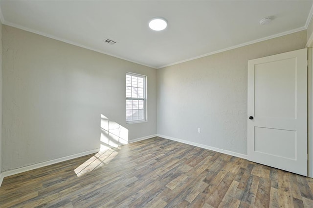 empty room with crown molding and dark hardwood / wood-style floors