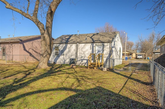 rear view of house with a yard