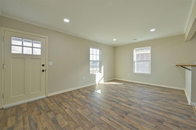 foyer with crown molding and dark hardwood / wood-style flooring