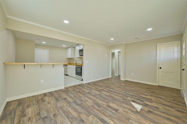 unfurnished living room with hardwood / wood-style floors and ornamental molding