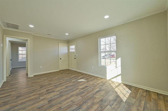 spare room with crown molding and dark hardwood / wood-style floors