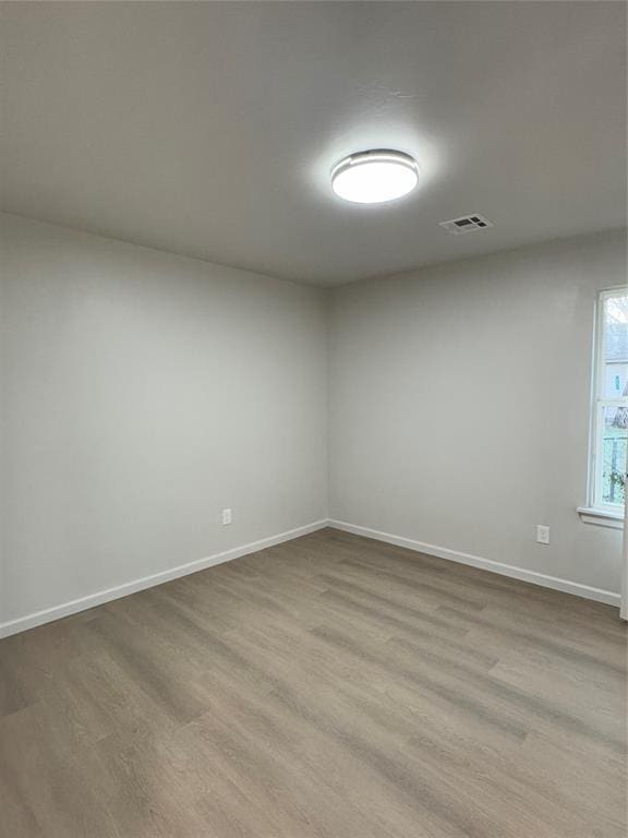 unfurnished room featuring light hardwood / wood-style flooring