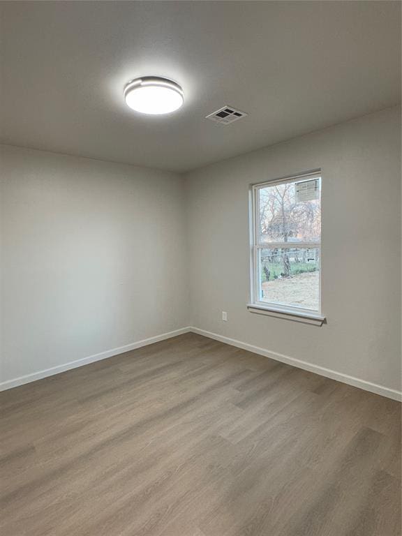 spare room featuring hardwood / wood-style flooring