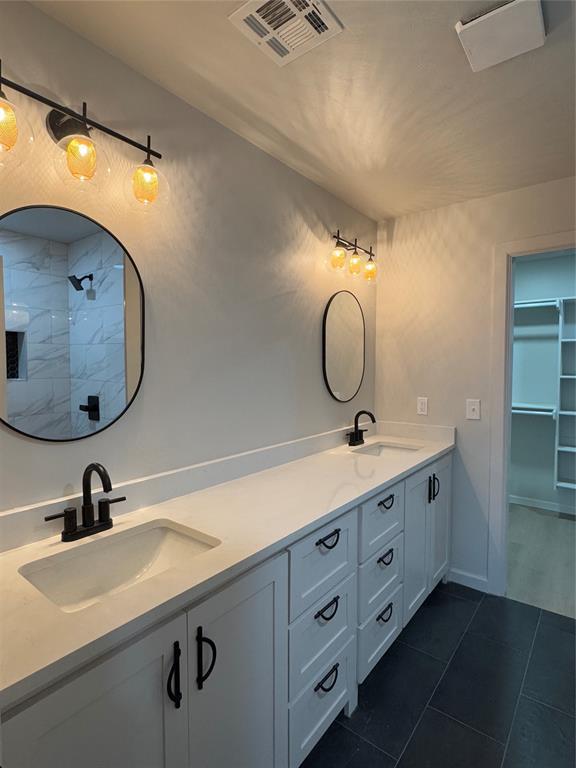 bathroom with tile patterned flooring and vanity