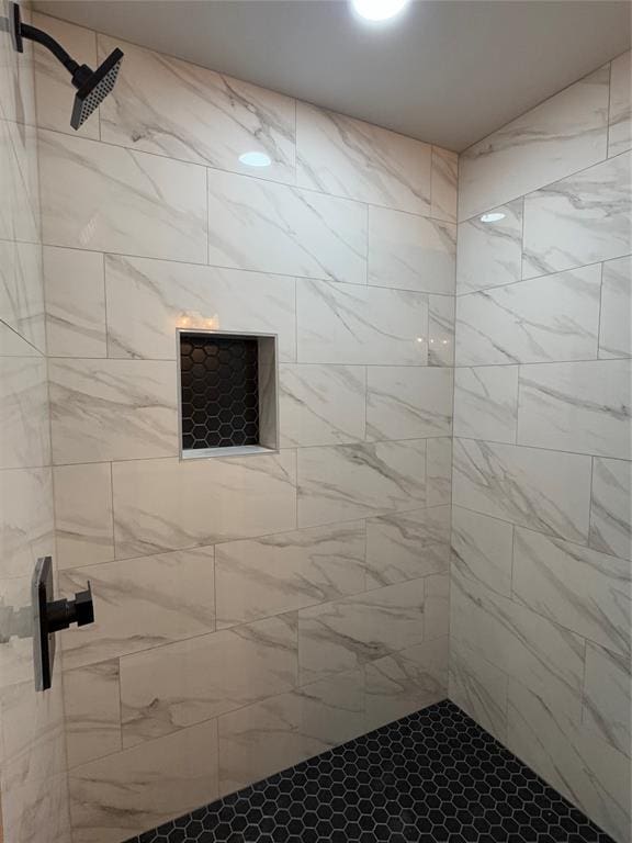 bathroom with tiled shower