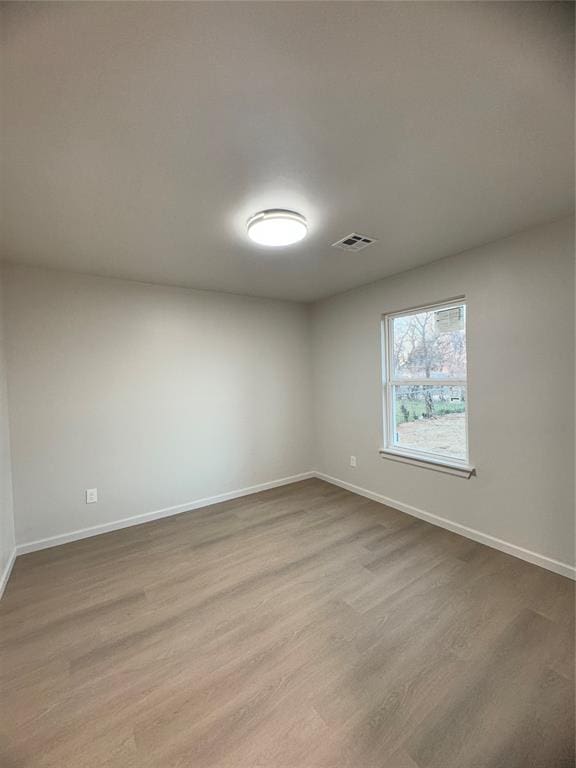 empty room with light hardwood / wood-style floors