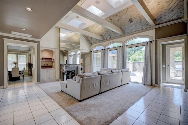 living room with plenty of natural light, light tile patterned floors, and high vaulted ceiling