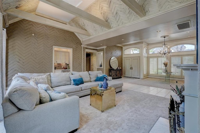 living room with lofted ceiling with beams, light tile patterned floors, and a chandelier