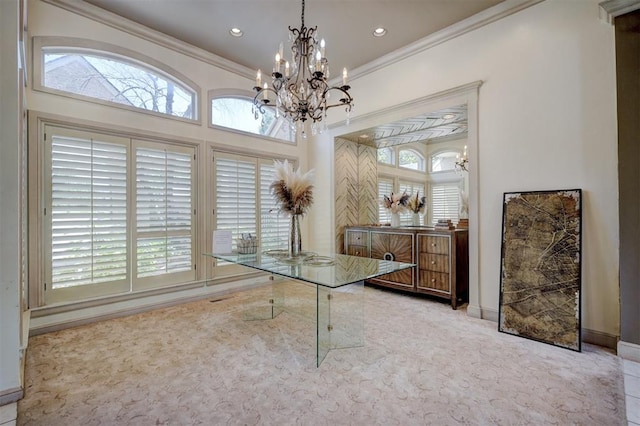 office space featuring light carpet, an inviting chandelier, a wealth of natural light, and ornamental molding