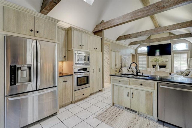 kitchen featuring beamed ceiling, high vaulted ceiling, sink, and appliances with stainless steel finishes